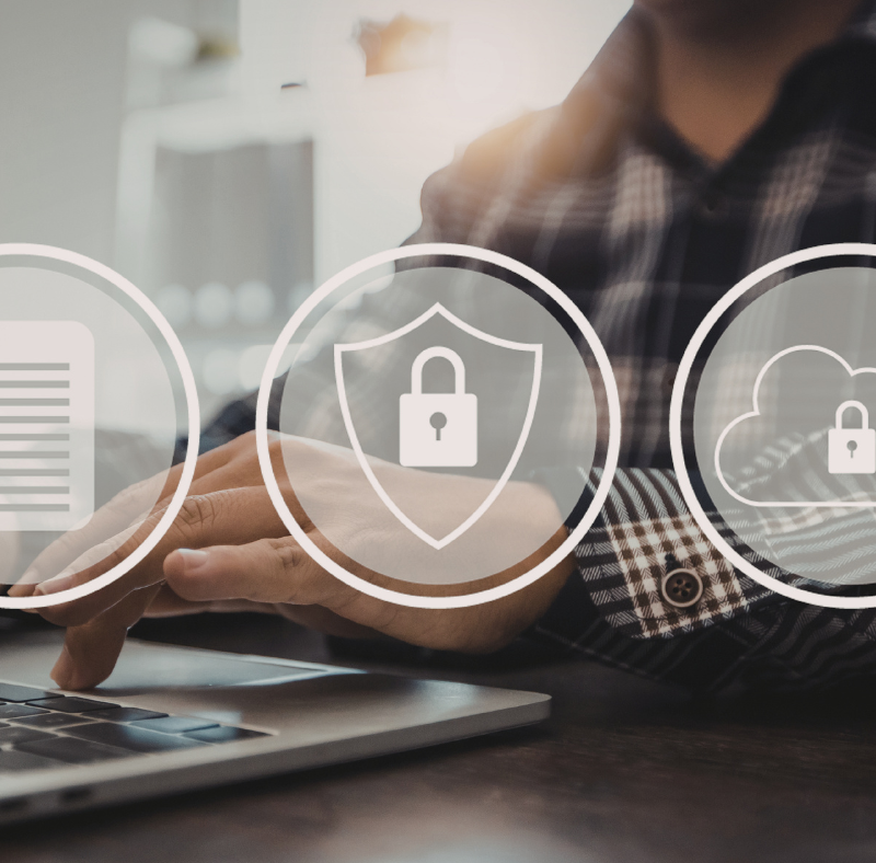 A person typing on a laptop with three logos on top of the image: a document, a padlock on a shield, and a padlock on a cloud.
