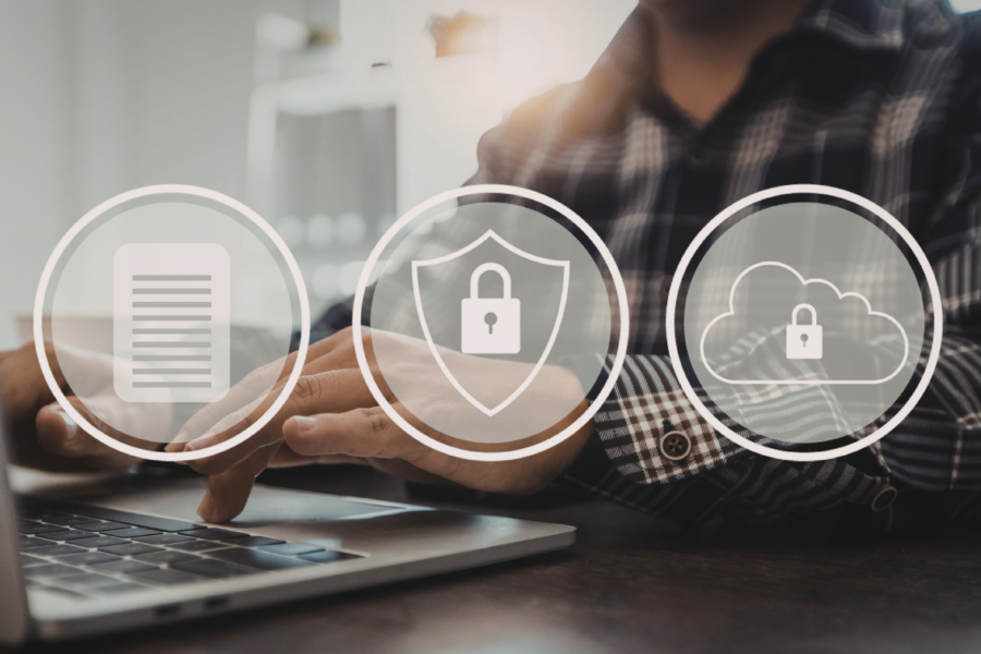 A person typing on a laptop with three logos on top of the image: a document, a padlock on a shield, and a padlock on a cloud.