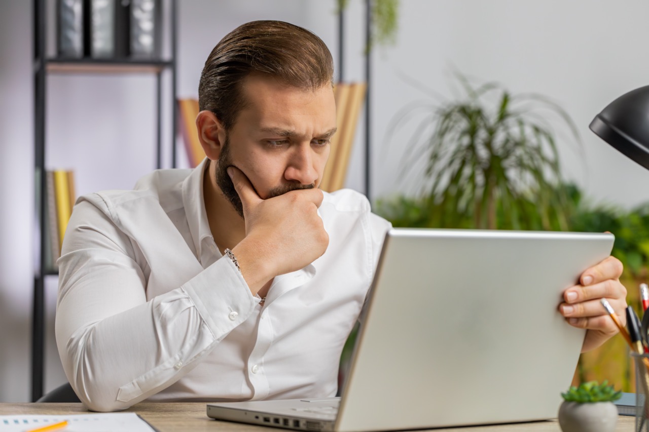 Irritated tired businessman working on laptop website problem, computer virus data loss by hacking
