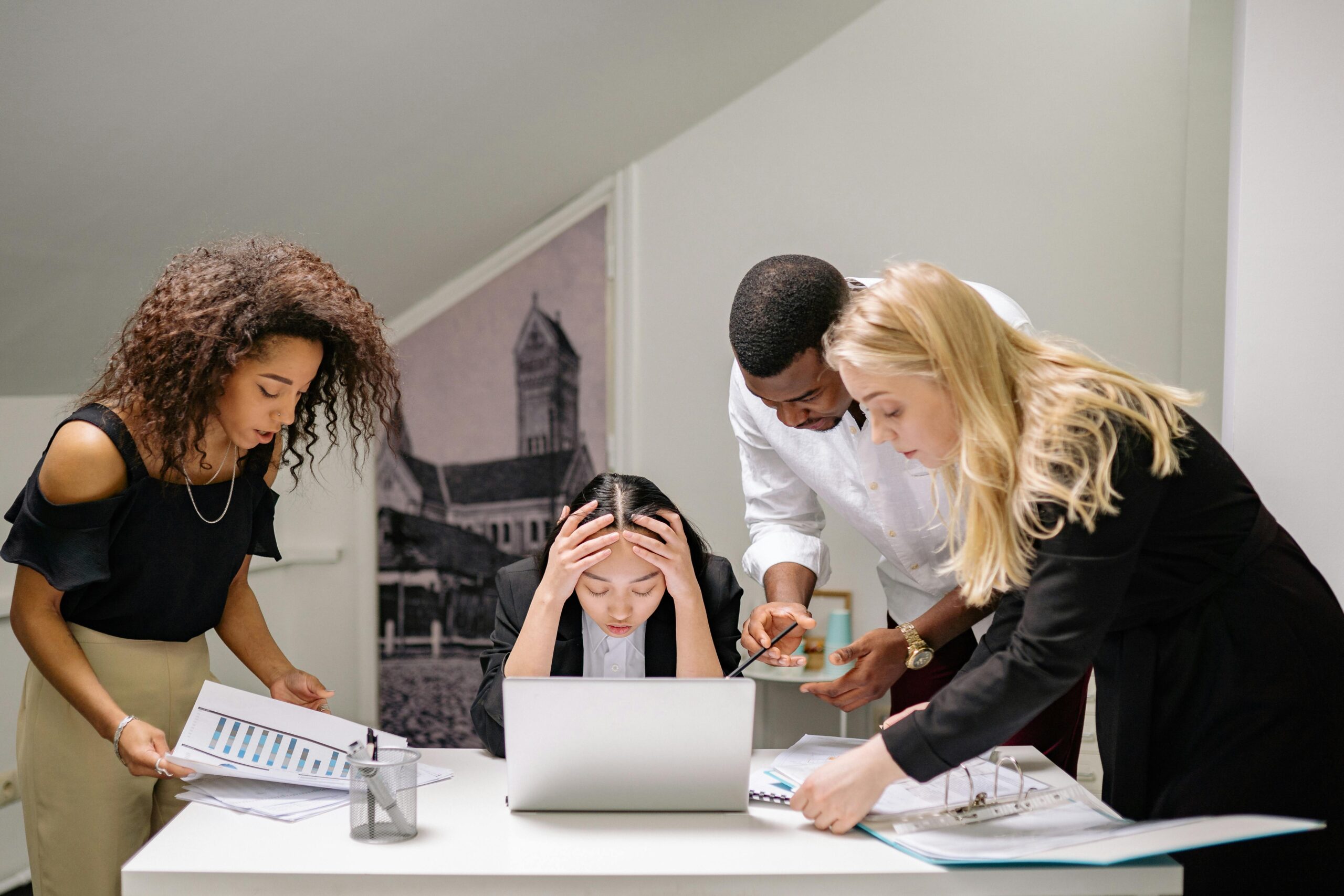 A group of professionals analyzes reports, addressing a potential cybersecurity breach.