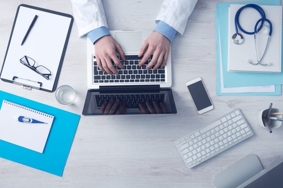 A healthcare provider uses secure digital tools, including laptops, tablets, and connected devices, to streamline patient care and manage medical data efficiently.