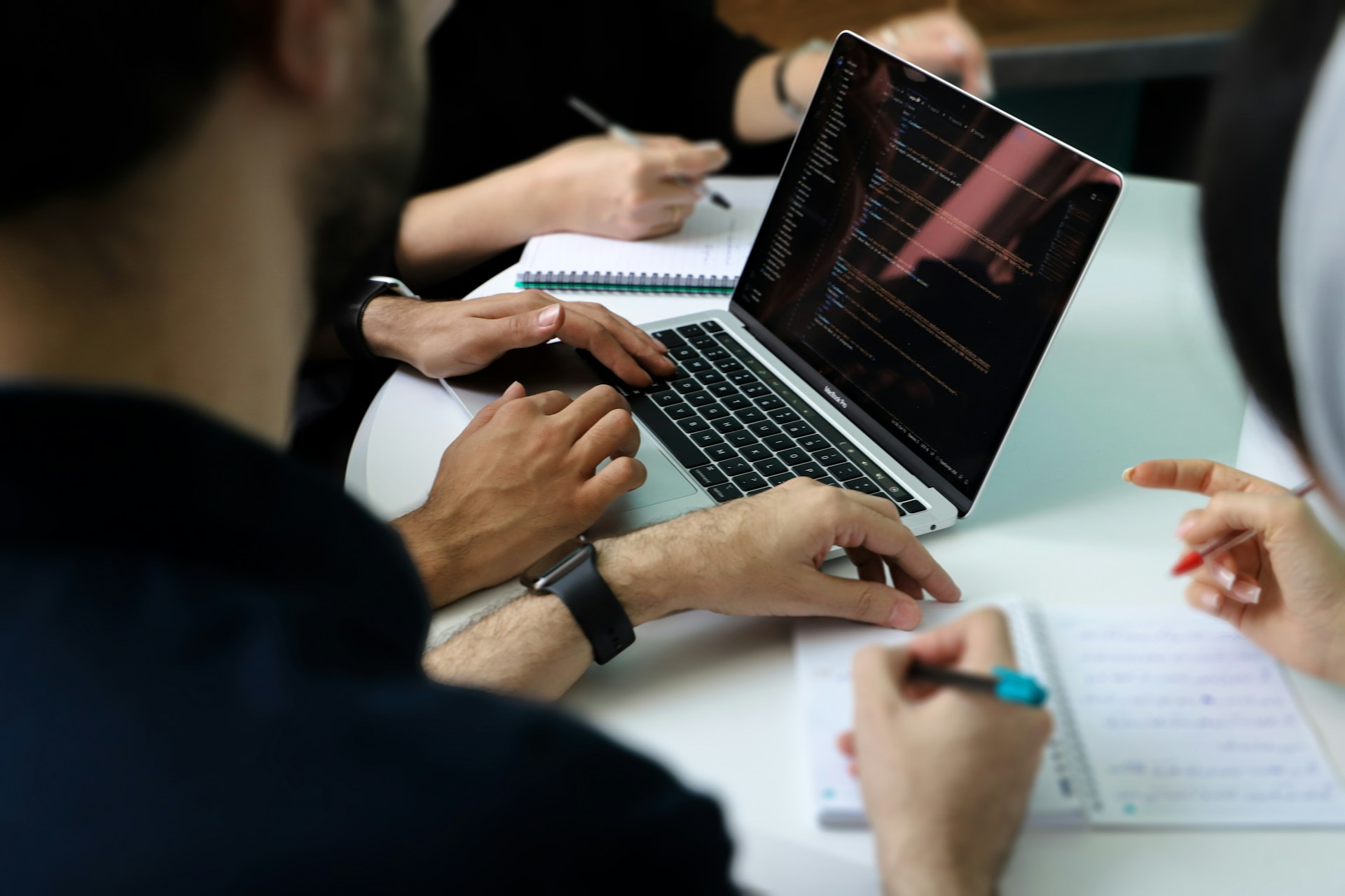 A team of executives reviews data and documents during a cyber risk assessment meeting.