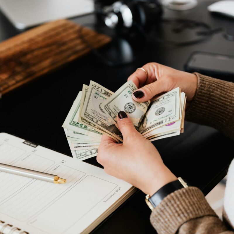 A finance leader counting money, representing cybersecurity budget planning.