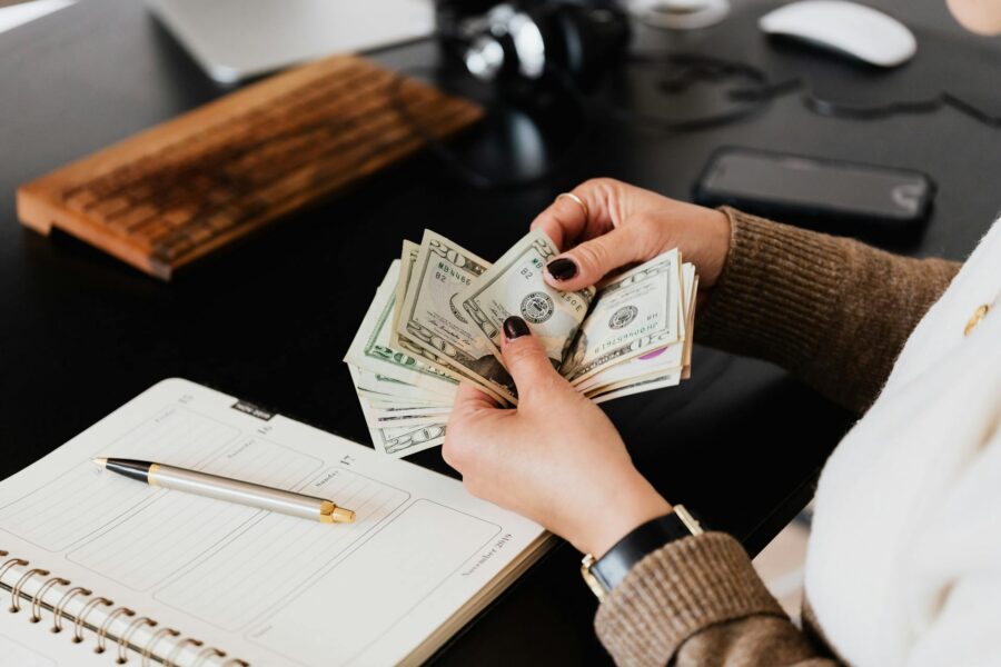 A finance leader counting money, representing cybersecurity budget planning.