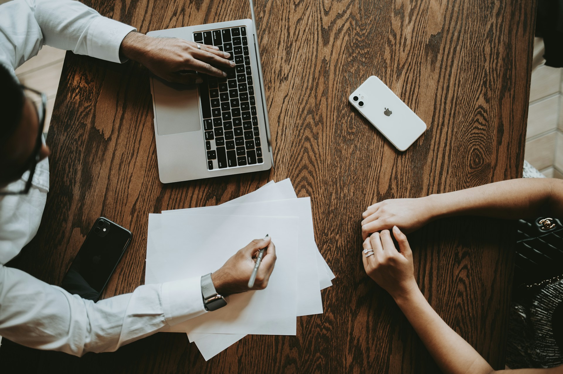 Business professional meets with a cybersecurity consultant to discuss cyber insurance and risk mitigation strategies.