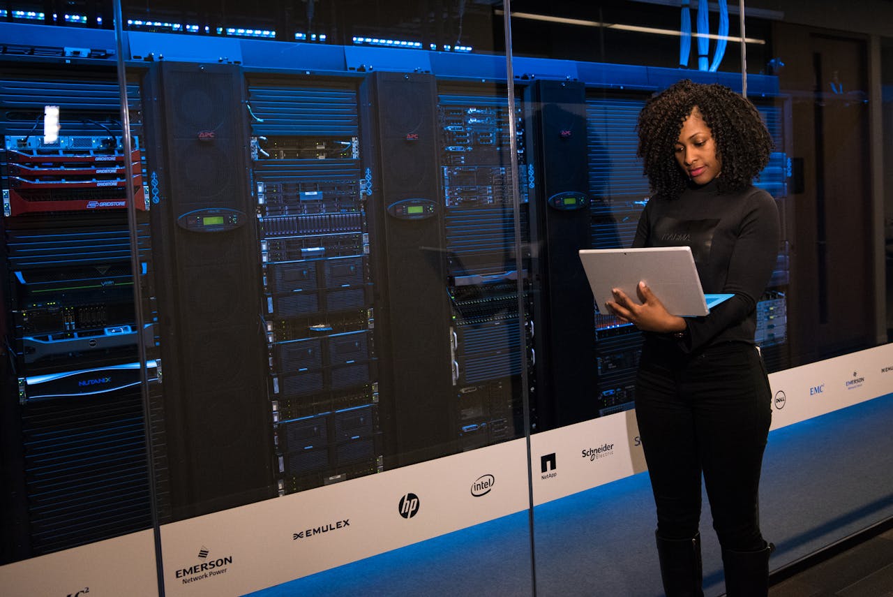 A business leader monitoring network security systems in a server room.