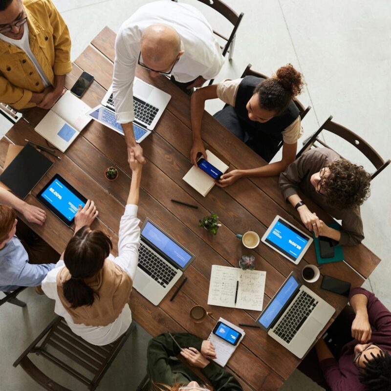 A team analyzes charts and data on digital devices, showing how collaboration tools support data-driven decisions and real-time teamwork.