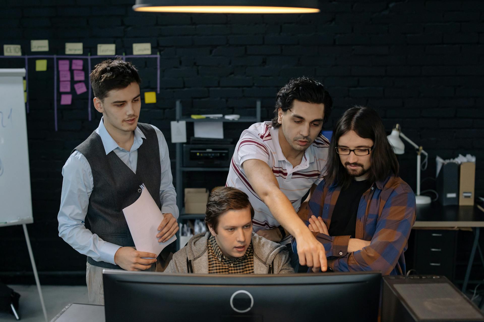 Employees collaborating on cybersecurity tasks as part of a company’s Cybersecurity Awareness Month initiatives.