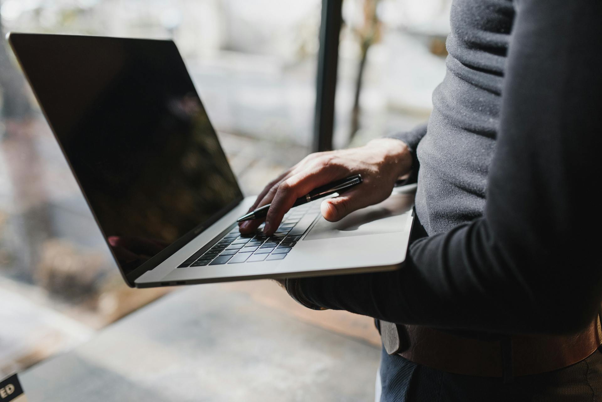 Person using a laptop to review reports generated with Microsoft AI tools for business.