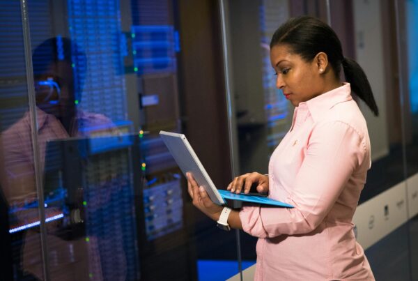 Software engineer using a laptop to monitor systems and manage IT disaster recovery processes.