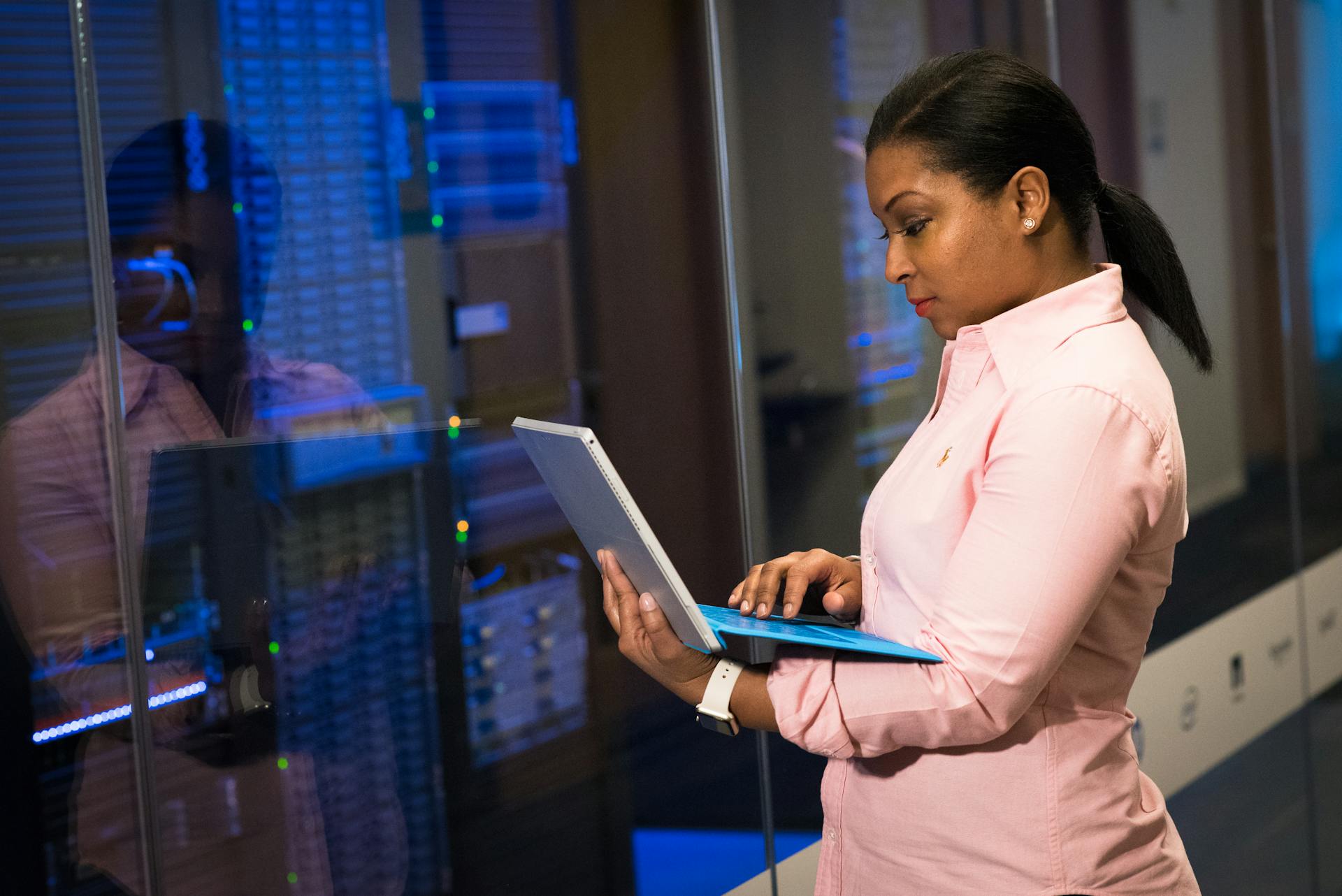 Software engineer using a laptop to monitor systems and manage IT disaster recovery processes.