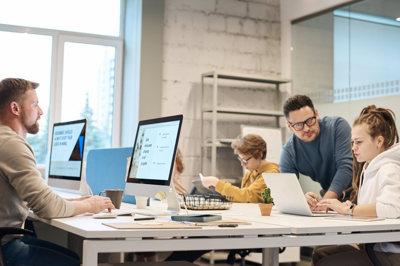 IT team reviewing computers and documents to prepare proof for a cyber insurance claim.