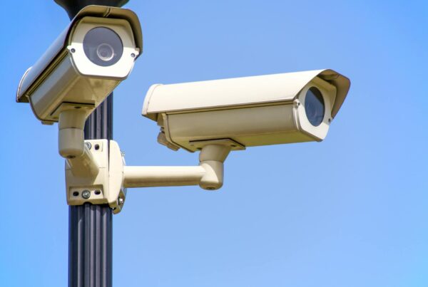 Two security cameras mounted on a pole, showing a video surveillance system used for monitoring and security.