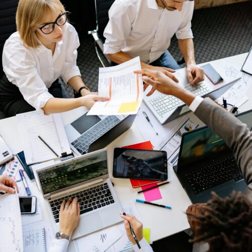 A team collaborating, analyzing data, and planning technology initiatives to optimize business performance before year-end.