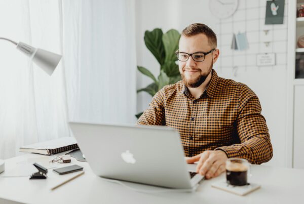 CEO using a laptop with Microsoft 365 Copilot.