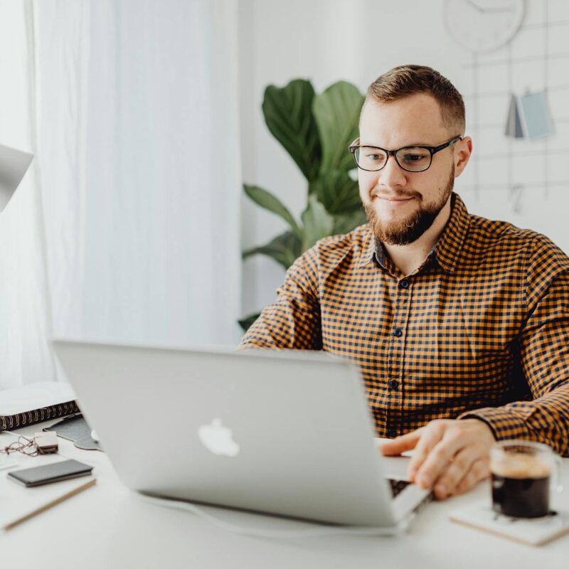 CEO using a laptop with Microsoft 365 Copilot.