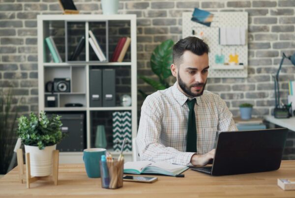 A professional uses AI-powered business tools on his laptop to streamline workflow and boost productivity.