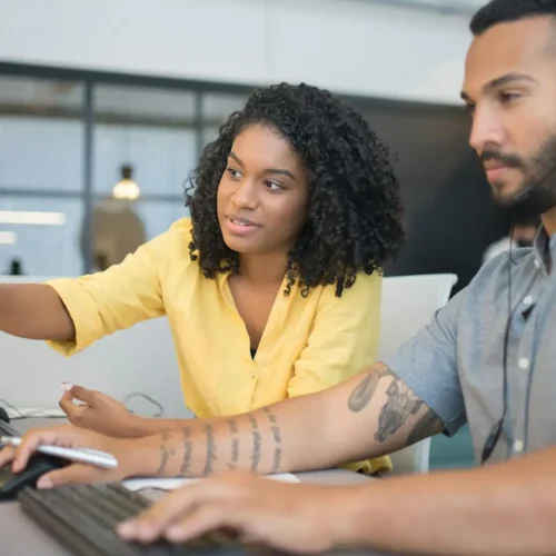 Colleagues handling tasks across systems, highlighting inefficiencies that can be solved by custom Microsoft 365 solutions and automation tools.