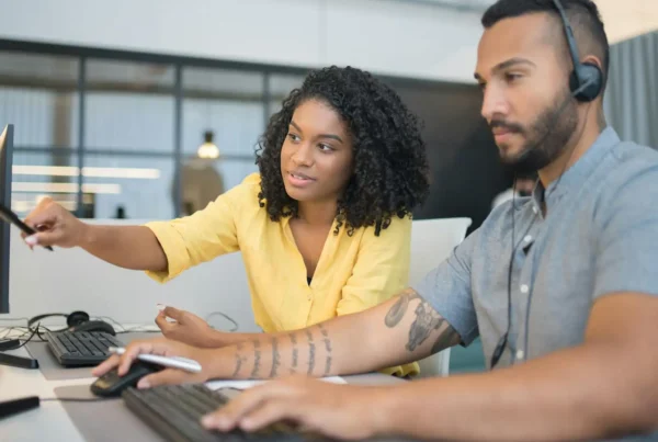 Colleagues handling tasks across systems, highlighting inefficiencies that can be solved by custom Microsoft 365 solutions and automation tools.