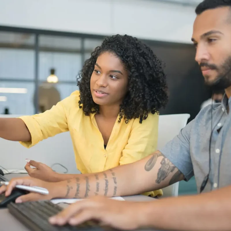 Colleagues handling tasks across systems, highlighting inefficiencies that can be solved by custom Microsoft 365 solutions and automation tools.