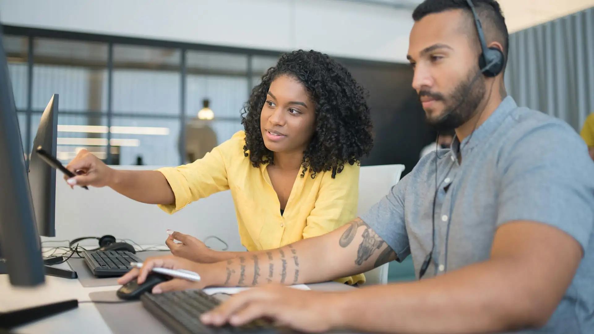 Colleagues handling tasks across systems, highlighting inefficiencies that can be solved by custom Microsoft 365 solutions and automation tools.