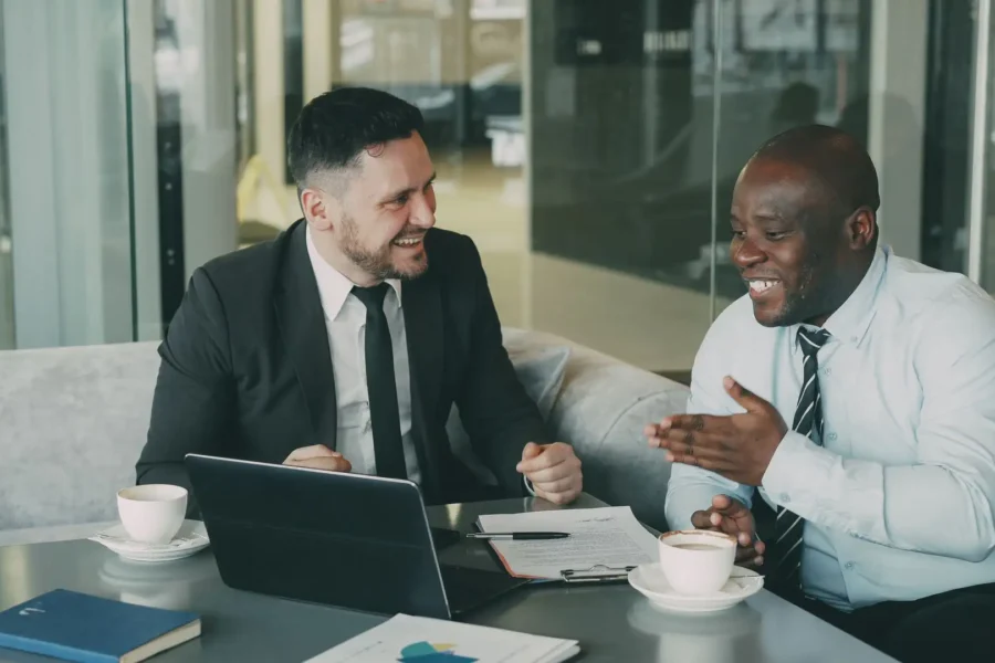 Two business professionals discuss contract terms to streamline operations through vendor consolidation.