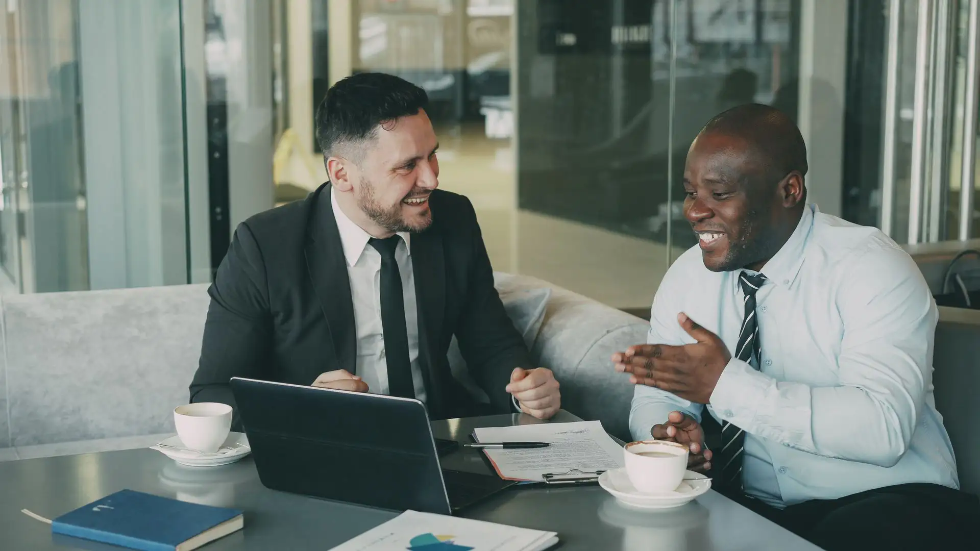 Two business professionals discuss contract terms to streamline operations through vendor consolidation.