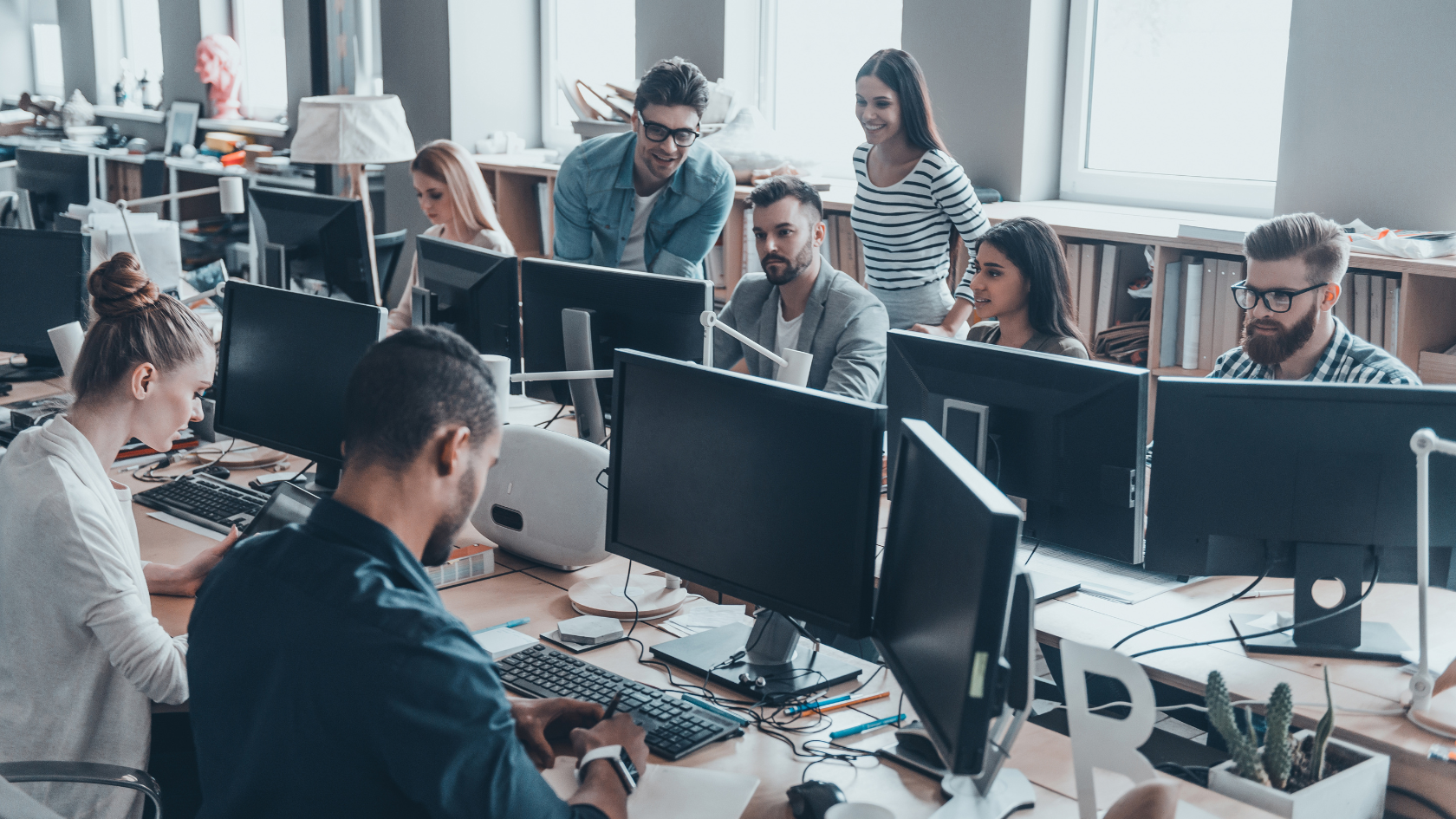 An office full of employees working on their computers.