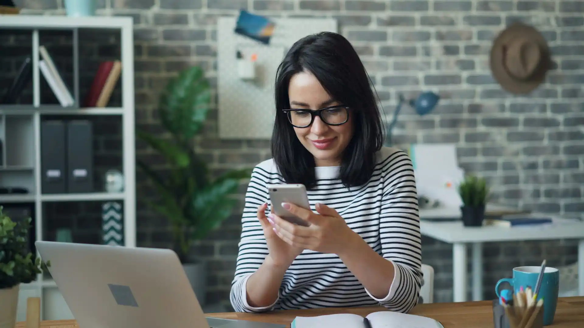 An employee using a smartphone for business texting in an office setting.