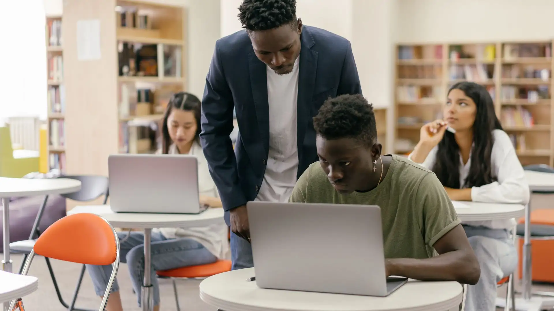 An educator oversees students, illustrating the human-led approach required by the Illinois AI guidelines for schools.