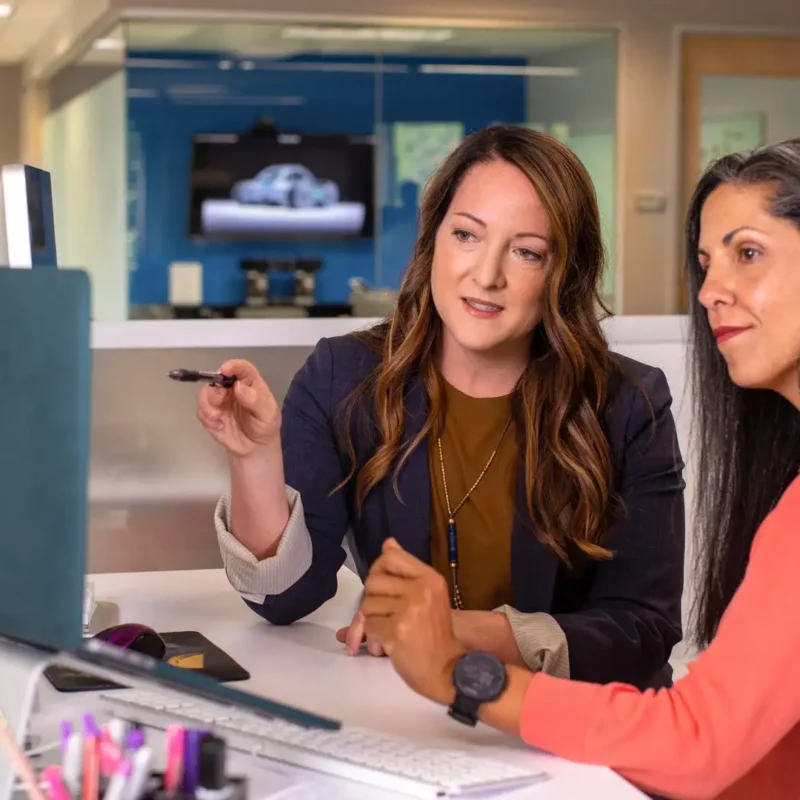 Two employees are analyzing SharePoint permissions that have grown overly complicated.
