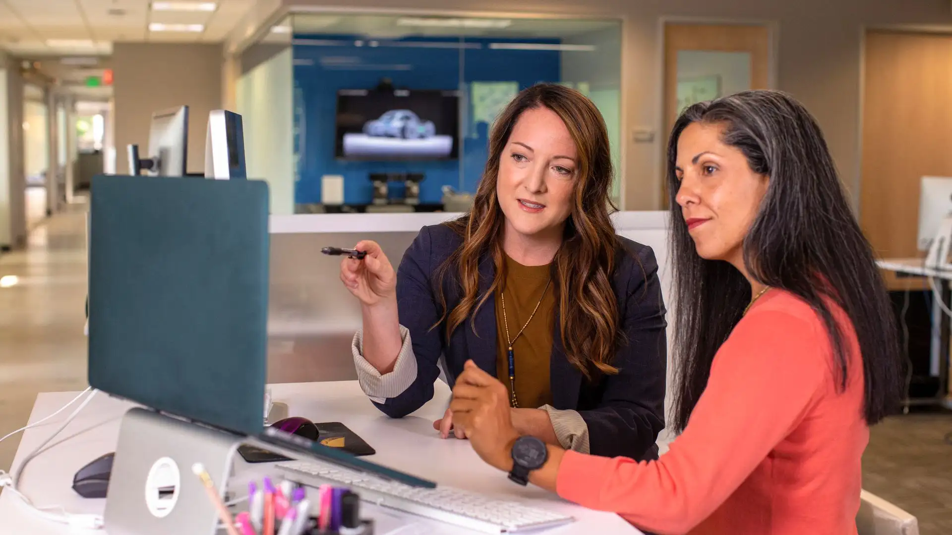 Two employees are analyzing SharePoint permissions that have grown overly complicated.